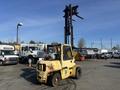 A yellow 1993 Hyster H80XL forklift with a raised mast and large tires is positioned in the foreground