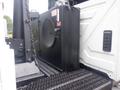 A black storage box mounted on the side of a 2012 International 7300 truck with a chain and latch mechanism visible