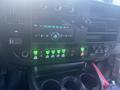 The dashboard of a 2017 Chevrolet Express featuring buttons and controls for various functions including a radio display and climate control settings