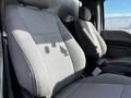 Two front seats of a 2018 Ford F-550 with gray fabric upholstery visible in the foreground