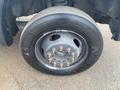 Close-up of a tire mounted on a 2009 Ford F-450 Super Duty with visible lug nuts and tire tread details