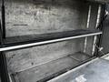 Interior view of a 2007 Ford F-550 truck bed showing empty metal compartments with a gray surface and no contents