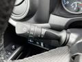 A close-up of the turn signal and headlight control stalk in a 2022 Toyota Tacoma