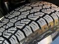 Close-up of a rugged tire tread on a 2011 Ford F-350 SD showing deep grooves and patterns designed for traction and durability