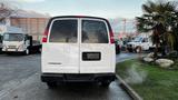 A white 2005 Chevrolet Express van viewed from the rear with no license plate attached