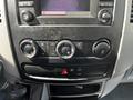 Dashboard controls of a 2017 Mercedes-Benz Sprinter with climate control knobs and a display screen
