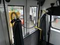 Interior view of a 2017 Chevrolet Express with secured folding seats and straps attached to the vehicle wall