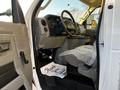 Interior view of a 2017 Ford Econoline with the driver's seat and dashboard visible along with a thank you note on the floor