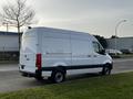 A white 2022 Mercedes-Benz Sprinter van is parked with its rear visible showcasing its sleek design and cargo space