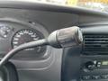 A close-up of a 2010 Ford Ranger's turn signal lever showing the on and off settings with mileage gauge in the background