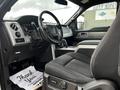 Interior view of a 2014 Ford F-150 featuring a steering wheel dashboard and front seat with a thank you note on the floor