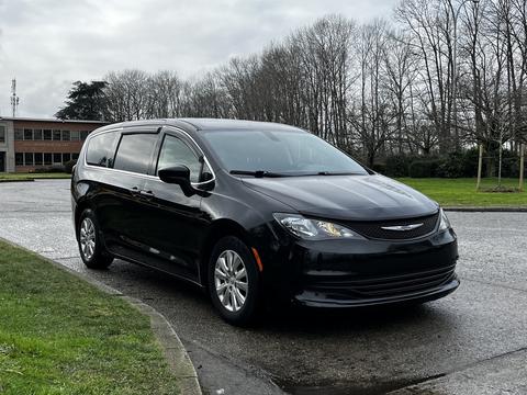 A 2018 Chrysler Pacifica in black is parked with its side profile displayed prominently