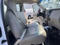 Interior of a 2008 Ford F-450 SD showing two front seats with seatbelts and the dashboard with controls visible