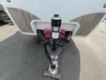 A 2013 Outdoor Wind River trailer hitch with a black coupler and a power connection box featuring two indicator lights mounted on a metal stand