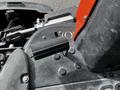 A close-up view of a black and gray Jacobsen Eclipse lawn mower with a prominent black attachment on its surface