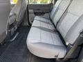 Interior view of a 2024 Ford F-550 featuring fabric seats with gray upholstery and a flat floor design