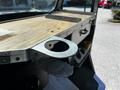 A close-up view of the metal work surface of a 2009 Morgan Olson Workhorse showing a circular cutout for a cup holder and a flat metal piece mounted on the edge