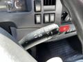 A close-up view of the control stalk for lights and wipers in a 2007 GMC W3500 interior showing various switch positions and indicators
