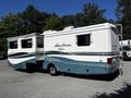 A 2000 Ford Motorhome with a light blue and white exterior featuring a slide-out section and the name "Pace Arrow" displayed on the side