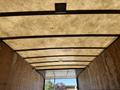 Interior view of a 2015 Freightliner M2 106 truck showing a wooden ceiling with a soft texture and overhead lighting