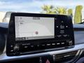2024 Kia Forte5 dashboard displaying navigation system and audio settings with a touchscreen interface and control buttons