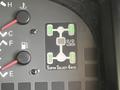 Control panel of a 2003 Mitsubishi Delica featuring indicators for Super Select 4WD and lock functions with red and green buttons