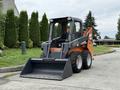 A 2017 Gehl R105 skid steer loader with a bucket attachment, featuring orange and black colors and large rubber tires