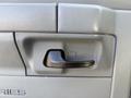 Close-up of the door handle on a 2012 Ford Econoline E-450 with a textured surface and a sleek black finish