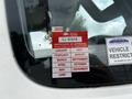 A red and white sticker on a vehicle window with text indicating a certificate of approval for 2025 and listing months along with a vehicle identification number