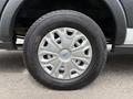 A close-up of a silver alloy wheel from a 2017 Ford Transit with ten spokes and a blue logo in the center