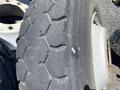 Set of 10 heavy duty tires displaying a rugged tread pattern with visible wear and a small nail embedded in one tire
