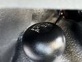 A close-up of the gear shift knob in a 2016 Ford F-550 displaying options for 2H 4H N and 4L