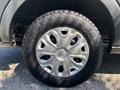 Close-up view of a silver alloy wheel with a radial tire on a 2016 Ford Transit