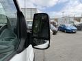 A 2017 Ford Transit van with a close-up view of its side mirror reflecting nearby cars
