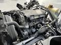 Close-up view of a 2015 Mitsubishi Fuso FE engine showing various components including hoses and the engine block