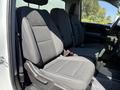 Two front seats of a 2022 GMC Sierra 1500 with gray cloth upholstery and a modern design