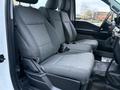 Interior view of a 2023 Ford F-250 showing two spacious front seats covered in gray fabric designed for comfort and durability