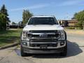 A white 2022 Ford F600 pickup truck viewed from the front with a prominent grille and headlights