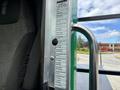 A 2013 Kenworth T370 door handle with a specifications label attached detailing various operational instructions and safety information