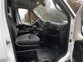 Interior view of a 2018 RAM Promaster showing the driver's seat and dashboard with controls and a spacious cabin design