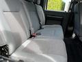 A gray interior bench seat in a 2016 Ford F-550 featuring fabric upholstery with a patterned design and seatbelts attached