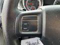 A close-up of the steering wheel controls in a 2011 Dodge Grand Caravan featuring buttons labeled STEP and RESET