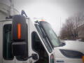 A 2008 International 7400 truck with a white cab and orange indicator lights on the side mirror and roof