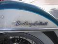 Close-up of the emblem on a blue and silver 2009 Harley-Davidson FLSTC Heritage Softail motorcycle