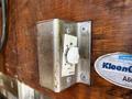 A metal timer switch mounted on a wooden panel with a white dial for minute adjustment and an OFF position