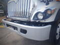 A 2016 International WorkStar 7500 truck front view showcasing its chrome grille and one headlight with a white painted bumper
