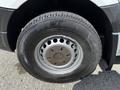 Close-up of a tire and wheel of a 2012 Mercedes-Benz Sprinter showing the rim design and tread pattern