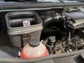 A 2019 Mercedes-Benz Sprinter engine compartment showing a coolant reservoir and an air filter housing with a warning label against improper use