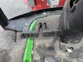 Close-up of the control pedals on a 2014 John Deere 1585 Terrain Cut showing two black pedals with textured surfaces