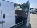 A 2016 GMC Savana van with an open side door revealing the interior seating and dashboard